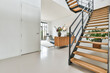 Designed in a minimalistic style staircase hall. Interior of luxury house stairs