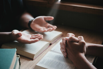 Wall Mural - Christians are congregants join hands to pray and seek the blessings of God. Devotional or prayer meeting concept.