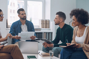 Sticker - Confident business team having meeting while sitting in the office together