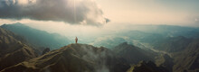 Man Standing On Mountain Top