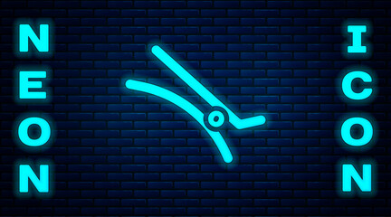 Poster - Glowing neon Hair clip icon isolated on brick wall background. Vector