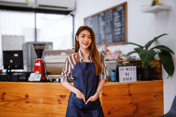 Portrait of Startup successful small business owner in a coffee shop.woman barista cafe owner. SME entrepreneur seller business concept	