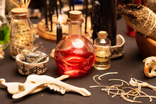 Witchcraft Table Set, Selective Focus At Potion Vial Or Glass Bottle With Magic Liquid Ingredient. Alchemy And Esoteric Items For Magic Cult At The Background. Spiritual Occultism And Magic Chemistry
