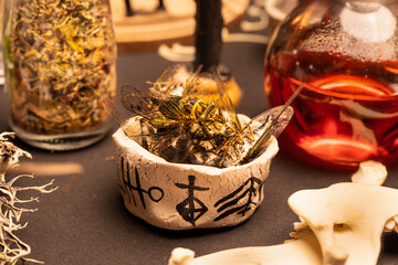 Wall Mural - Witchcraft magic cicada insects in the bowl with symbols on witch table. Background with magic items. Occult and esoteric concept. Mystic Halloween. Magic chemistry and witchcraft.