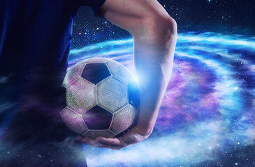 Soccer player holds the ball in the universe