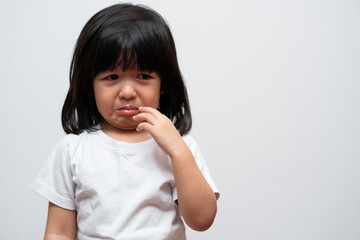 Portrait of Asian angry, sad and cry little girl on white isolated background, The emotion of a child when tantrum and mad, expression grumpy emotion. Kid emotional control concept