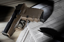 Tan Polymer Semi Auto Handgun On The FBI NICS Background Check Forms In Public Domain