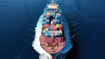 Wall Mural - Aerial drone video of huge container carrier tanker ship front bow cruising deep blue open ocean sea