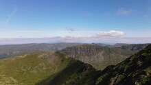 View Over The Surrounding Landscape With Blue Sky From Helvellyn Peak, Lake District, Cumbria, England - Aerial Drone Shot