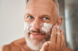 © Yakobchuk Olena - Mature man applying shaving foam on beard on face