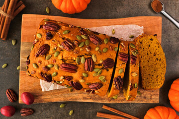Aufkleber - Autumn pumpkin bread sliced. Above view table scene over a dark background.