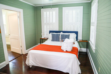 Wall Mural - A master bedroom bedroom with a king sized bed and a fan at a short term rental small cottage style house