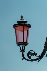 Sticker - Vertical shot of a street light against a blue sky in Venice, Italy