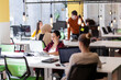© Nikola Spasenoski - Creative team of young individuals working on desktop computers in a modern office space.
