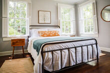 A Guest Bedroom With A Queen Sized Bed And Nightstand At A Short Term Rental Small Cottage Style House