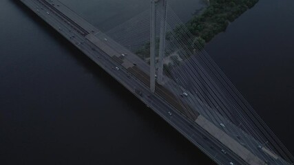 Wall Mural - Aerial view from drone to bridge with cables and car traffic at dusk