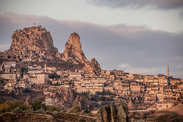 Wall Mural - Uchisar, Turkey, old cave houses and modern housing in the morning glow