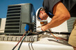 © spatesphoto - HVAC technician brazing on a condenser