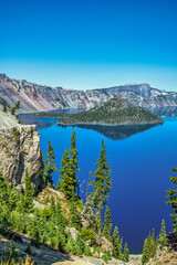 Wall Mural - blue lake in the mountains with large volcanic cinder cone island.
