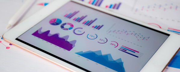 Report graph and chart of investment with finance on tablet computer on desk, datum of stock and growth, planning and statistic with economic, no people, digital marketing, business concept.