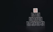© tete_escape - Leadership,  human resource management and recruitment business concept. Red human icon symbol on white dice blocks with black pieces, pyramid shape on dark background with copy space, minimal style.