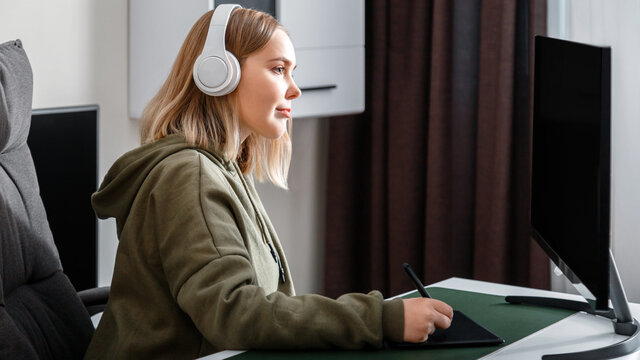Young woman graphic designer freelancer busy working remote from home using pc computer and graphics tablet in living room interior. Casual teenager girl in studying visual arts. Long web banner