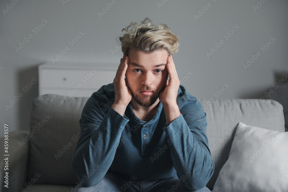 Depressed young man at home