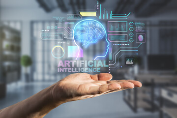 Poster - Close up of hand holding abstract glowing AI head interface on blurry office room background. Artificial intelligence and cyberspace concept. Double exposure.