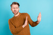 Photo of unhappy disgusted young man look hold hands empty space refuse isolated on blue color background