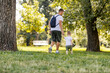 © Dusan Petkovic - Weekend for family activities. The little boy walks over to. Dad and holds his hand. Father and son connected, healthy lifestyle. Photo shoot from the back family weekend, what a dad such a son