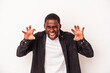 © Asier - Young African American man isolated on white background showing claws imitating a cat, aggressive gesture.