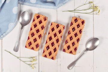 Sticker - Rectangular slices of pie called 'Linzer Torte', a traditional Austrian shortcake pastry topped with fruit preserves and sliced nuts with lattice design