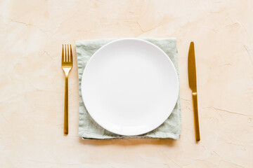 Wall Mural - Dinner plate setting with cutlery and napkin. Top view