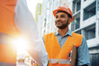 © fotofabrika - Two men engineers in workwear shaking hands against construction site.