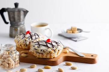 Poster - frangipane pie. Homemade frangipane cake made from almonds with sugar glassing and a cherry on top and a coffee on the side. Top view.