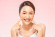 © 220 Selfmade studio - Young Beautiful Asian woman smile touching soft cheek with clean and fresh skin Happiness and cheerful with positive emotional,isolated on pink background,Beauty Cosmetics and spa Treatment Concept