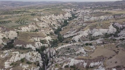 Sticker - An aerial view of a rocky surface and blue sky on the horizon in Capadoccia, Turkey