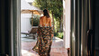 © Jacob Lund - Rearview of a woman in a gown and a bikini at a spa resort