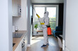 © H_Ko - Man in protective suit treating with disinfectant flat