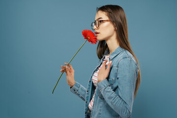 Wall Mural - pretty woman wearing glasses red flower summer style blue background