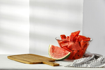 Sticker - Fresh tasty watermelon on desk and white wall with shadows. 