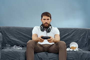 Wall Mural - Man sitting on the couch playing fun and rest