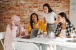 © Drobot Dean - Multiracial young women discussing project during meeting