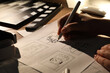 Leinwandbild Motiv Woman drawing cartoon sketches at workplace, closeup. Pre-production process