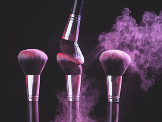 Wall Mural - Make-up brush with purple powder explosion on black background