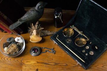 Antique jeweller's scale in velvet box with a collection of natural and vintage items.