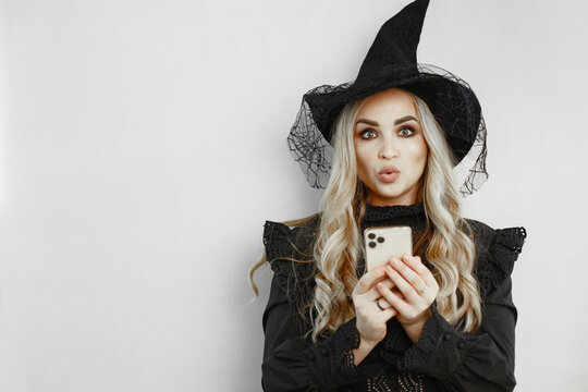 woman wearing black costume. lady with halloween makeup. girl on a white background.