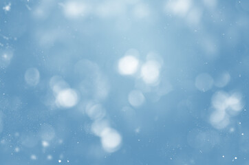 Wall Mural - blurry blue background with snowflakes and bokeh