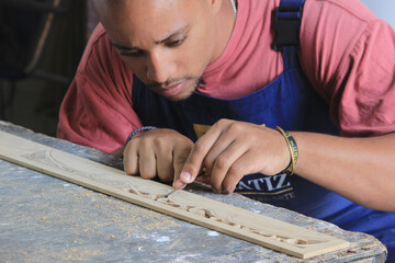 Canvas Print - Hispanic male restoring some vintage furniture in Cuba