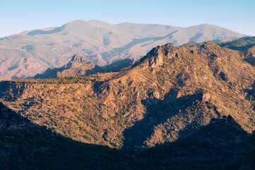 Wall Mural - Rocky mountains at sunrise. Far away distant zoom view. National parks and travel concept